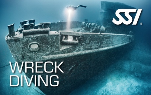 Underwater view of a shipwreck with a diver exploring it