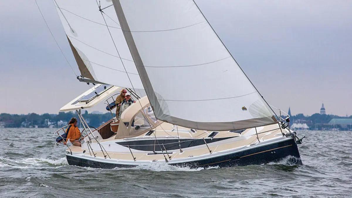 Sailboat under sail with crew on board